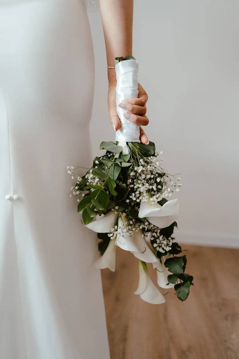 Buket u ruci mladenke Marsela u svilenoj vjenčanici – elegantan trenutak snimljen u Našicama.